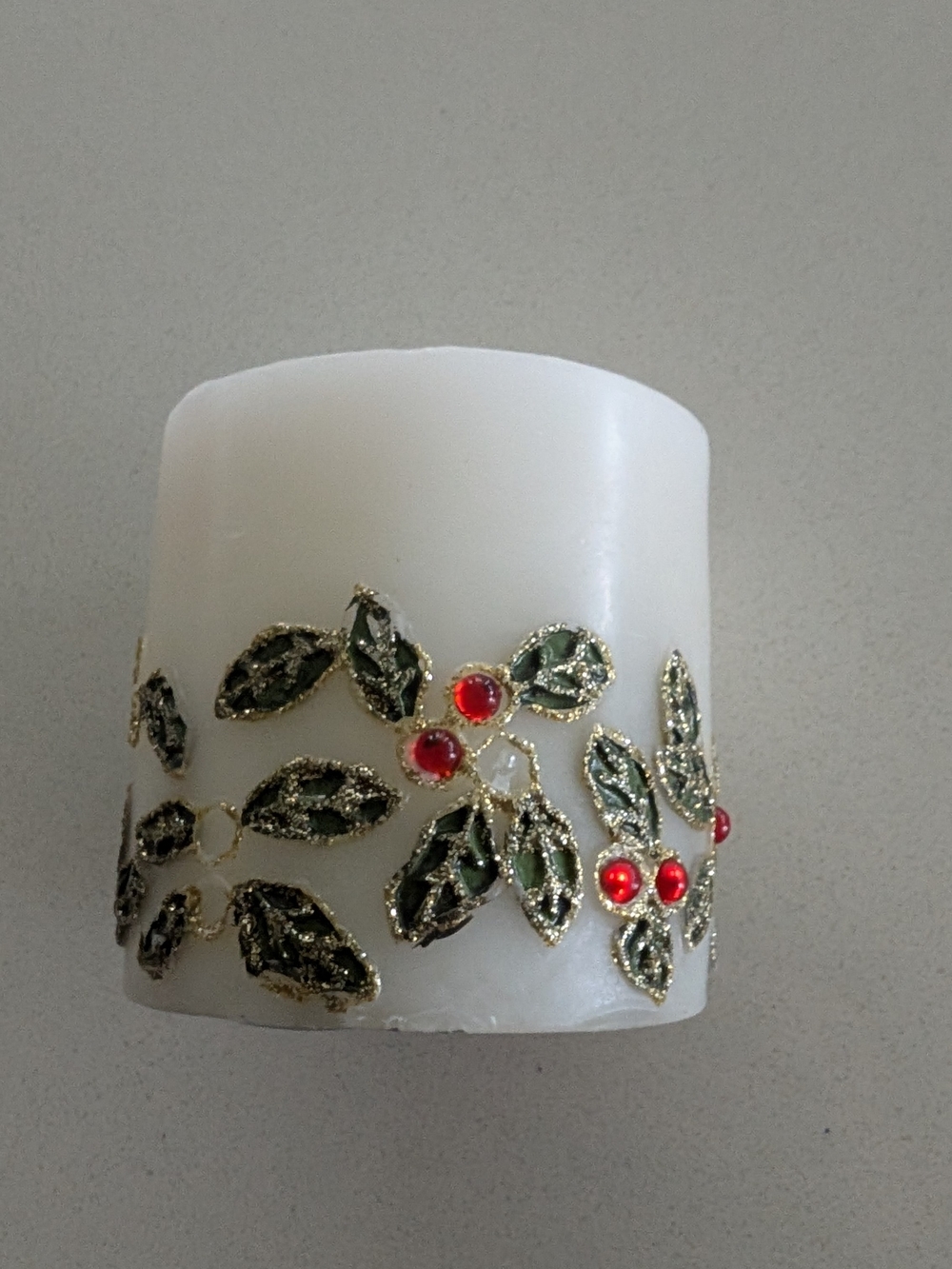White Decorative Candle with Green Leaf and Red Berry Accent